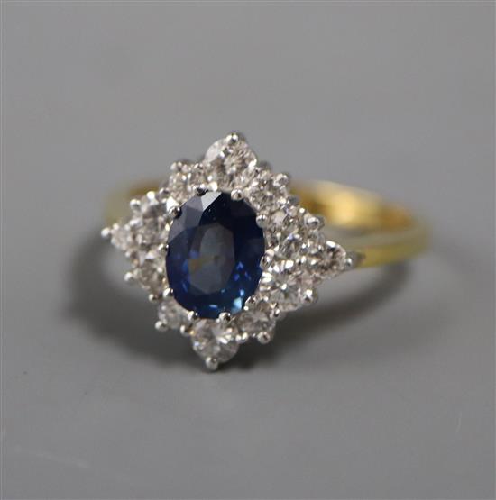 A modern 18ct gold, sapphire and diamond set cluster ring, size Q/R.